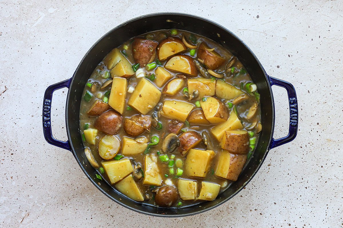 Pork and potatoes skillet dish preparation, a recipe from Taste of Home.