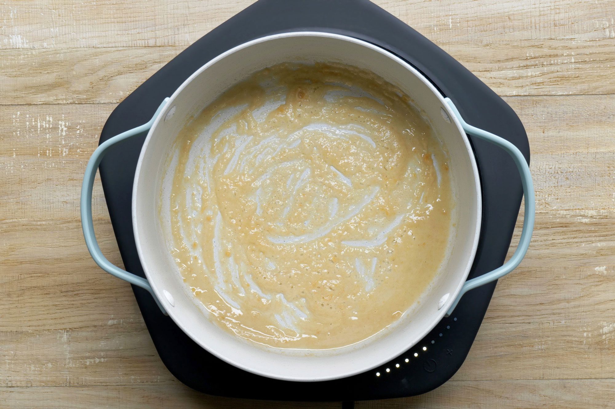 overhead shot; wooden background; In a large saucepan, cooking flour and garlic powder;