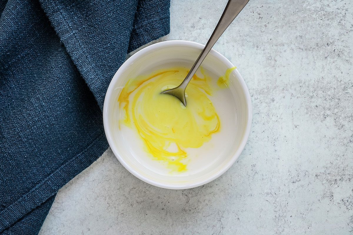 Powdered sugar glaze preparation with confectioners sugar and some food coloring.