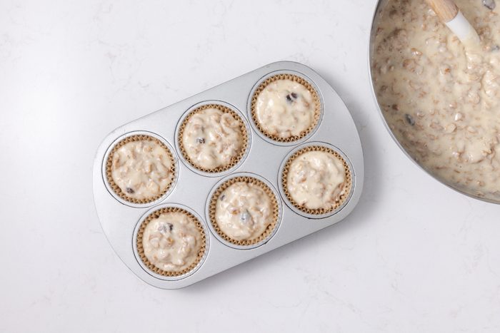 Muffins cup filled with dough ready to be baked.