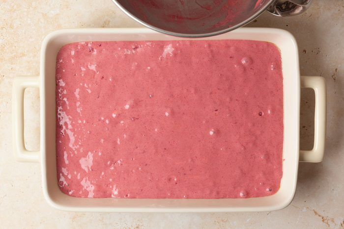 Step 2 of Taste of Home Raspberry Cake is to pour the batter into a greased 13x9-inch baking pan. Bake for 35 to 40 minutes in your preheated oven or until a toothpick inserted in the center comes out clean. Once baked, let the cake cool completely in the pan on a wire rack.