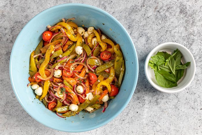Taste of Home Roasted Pepper Salad photo of the tomatoes and mozzarella perals added to the salad.