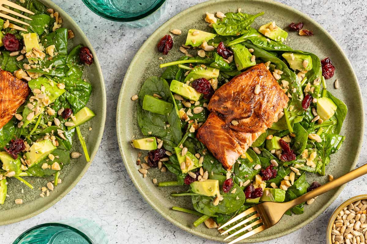 Taste of Home Salad with Salmon recipe photo of the finished recipe served on plates.