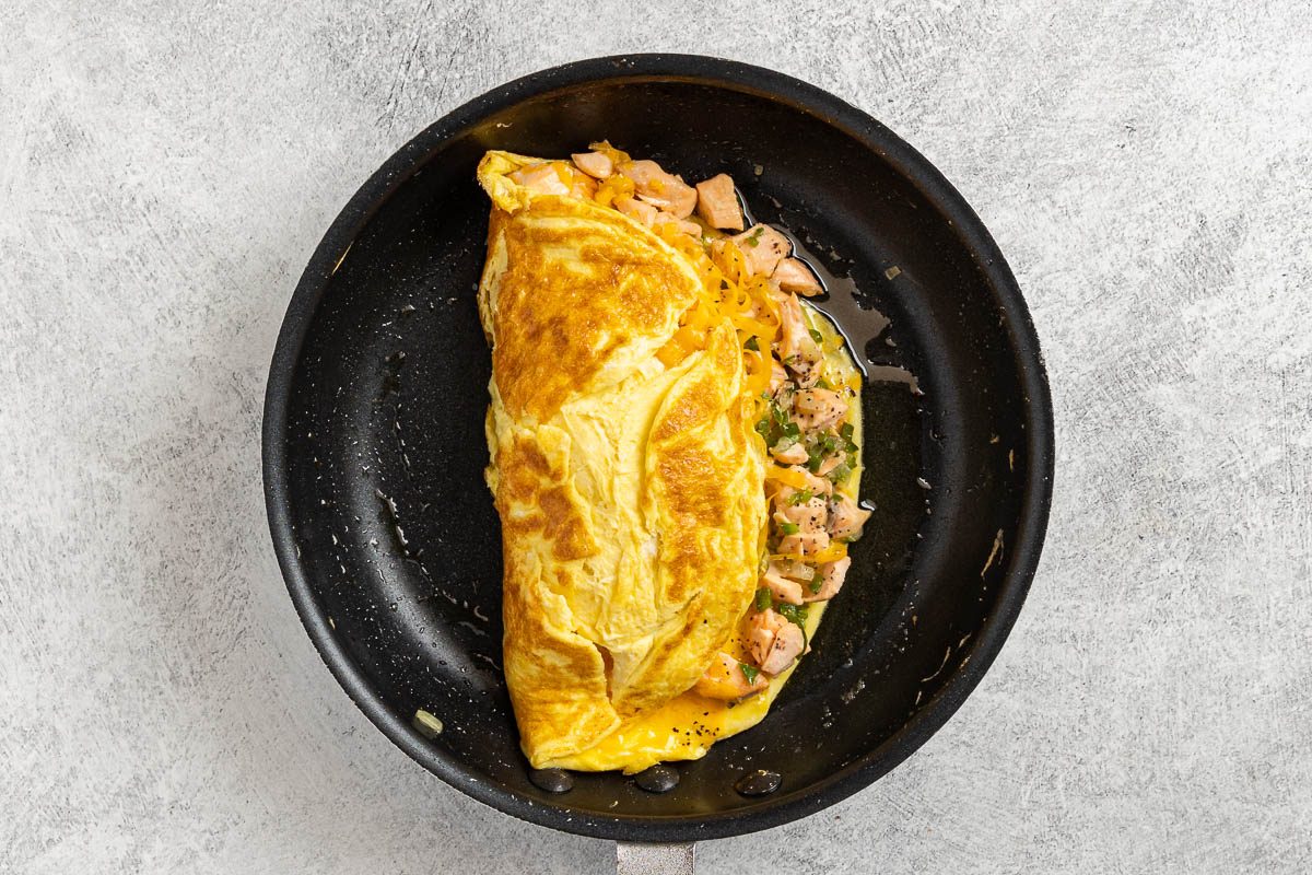 Taste of Home Salmon Omelet recipe photo of adding the salmon filling and folding the omelet.