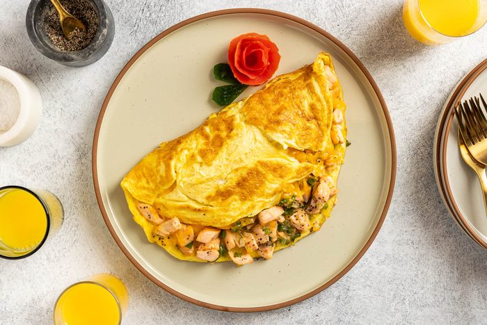 Taste of Home Salmon Omelet recipe photo of the finished omelet served on a plate.