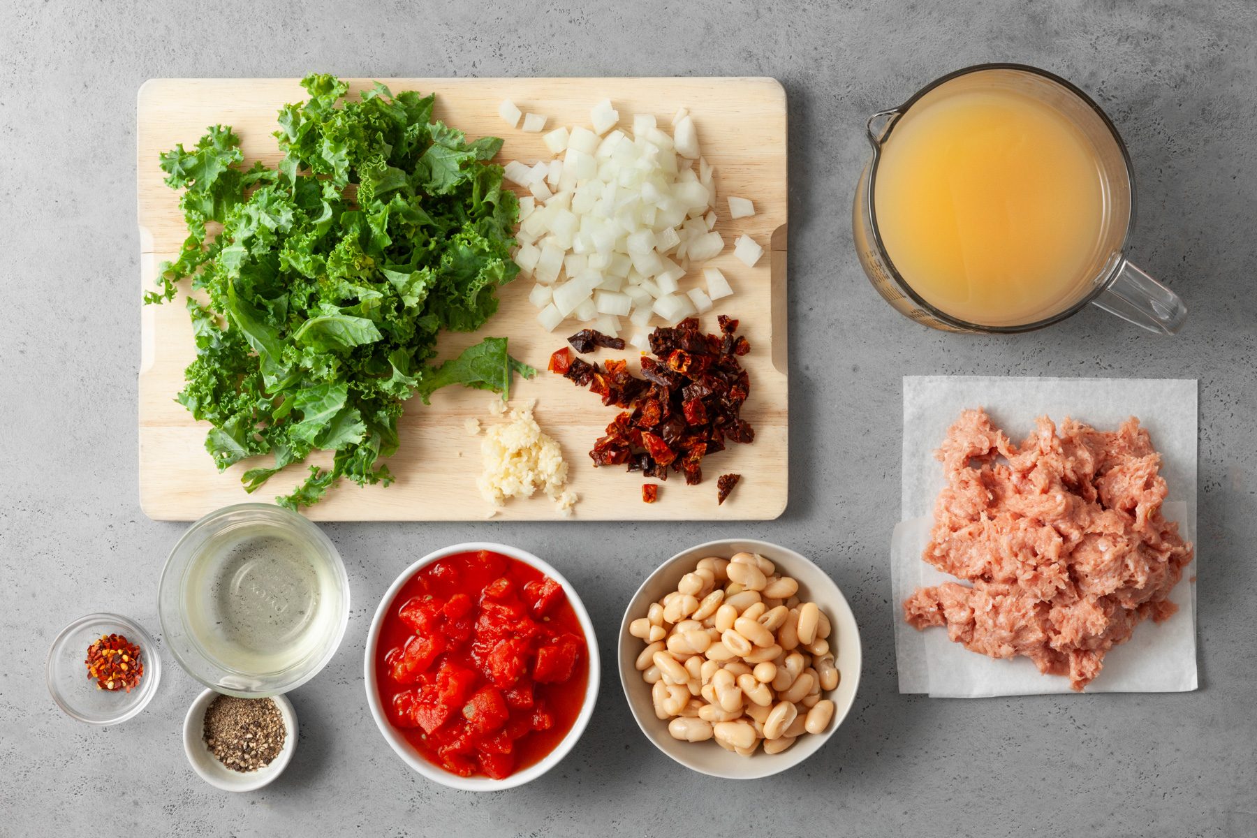 Overhead shot of all ingredients; wooden chopping board; grey marble surface