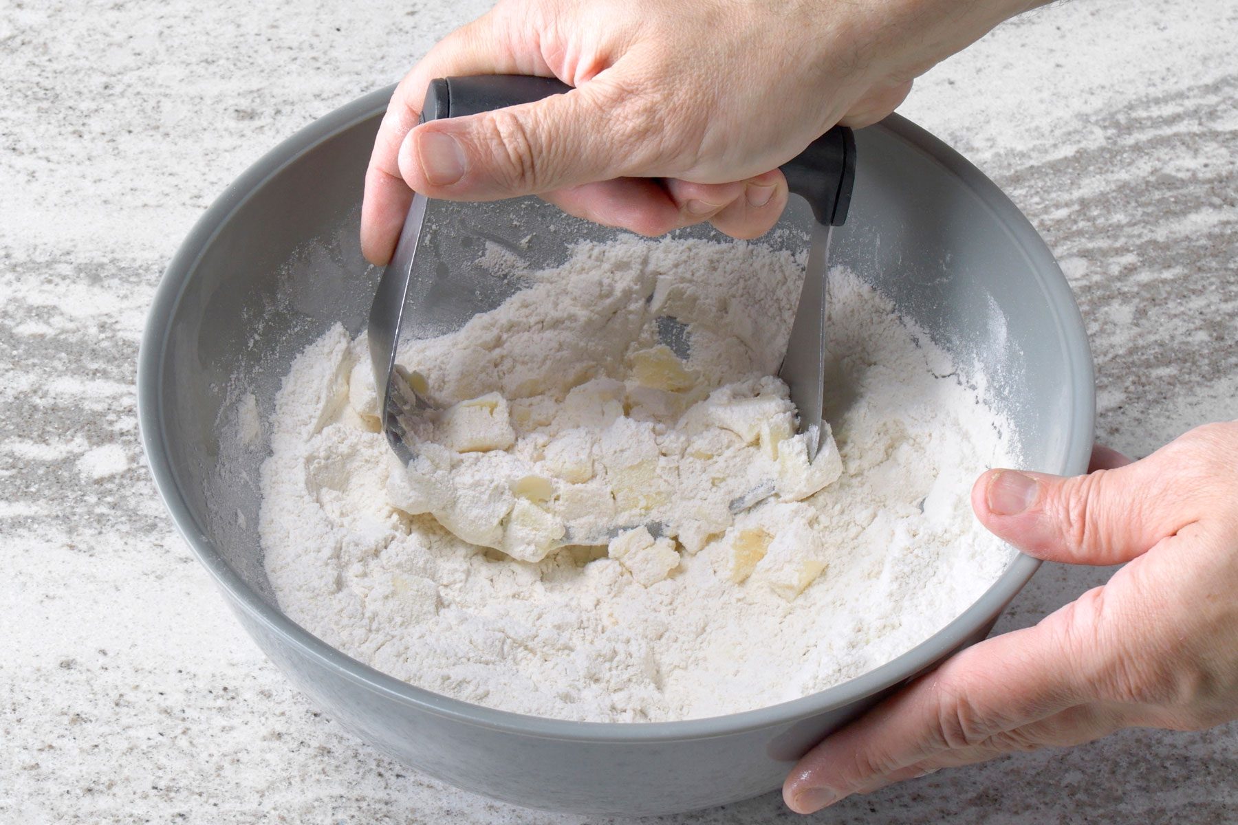 All-purpose flour, sugar, baking powder and baking soda whisked together in a large bowl mixed with butter.