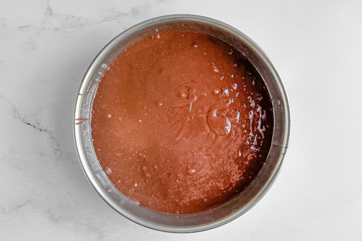 Brownie layer in a springform pan for Taste of Home Snickers Cheesecake