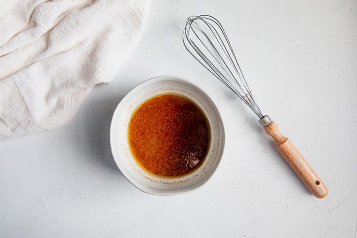 Overhead shot for Taste of Home Southwest Chicken Salad, salad dressing in a small bowl.