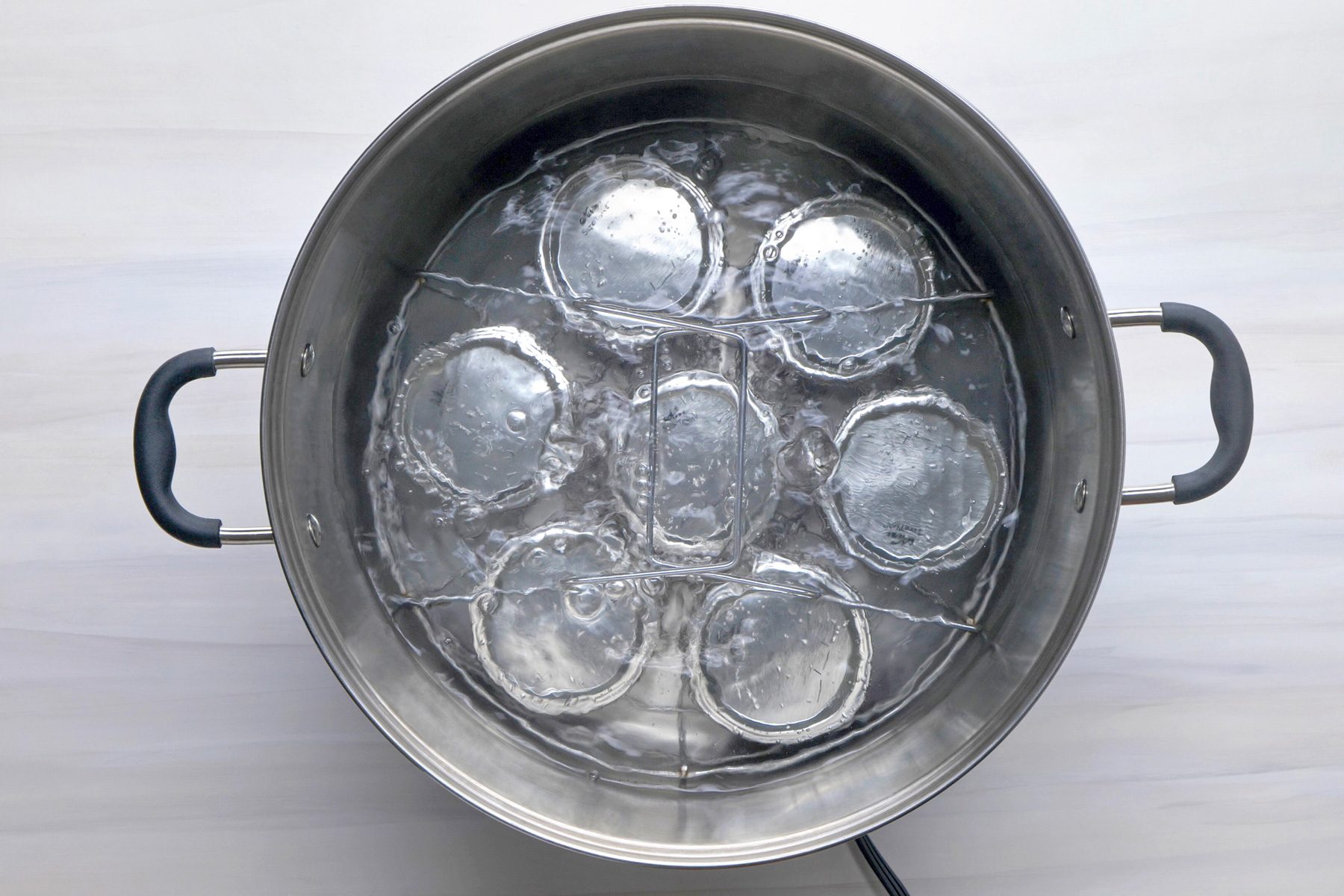 Overhead shot; ensuring that they are completely covered with water; bring to a boil; process for 10 minutes; remove jars and cool; induction