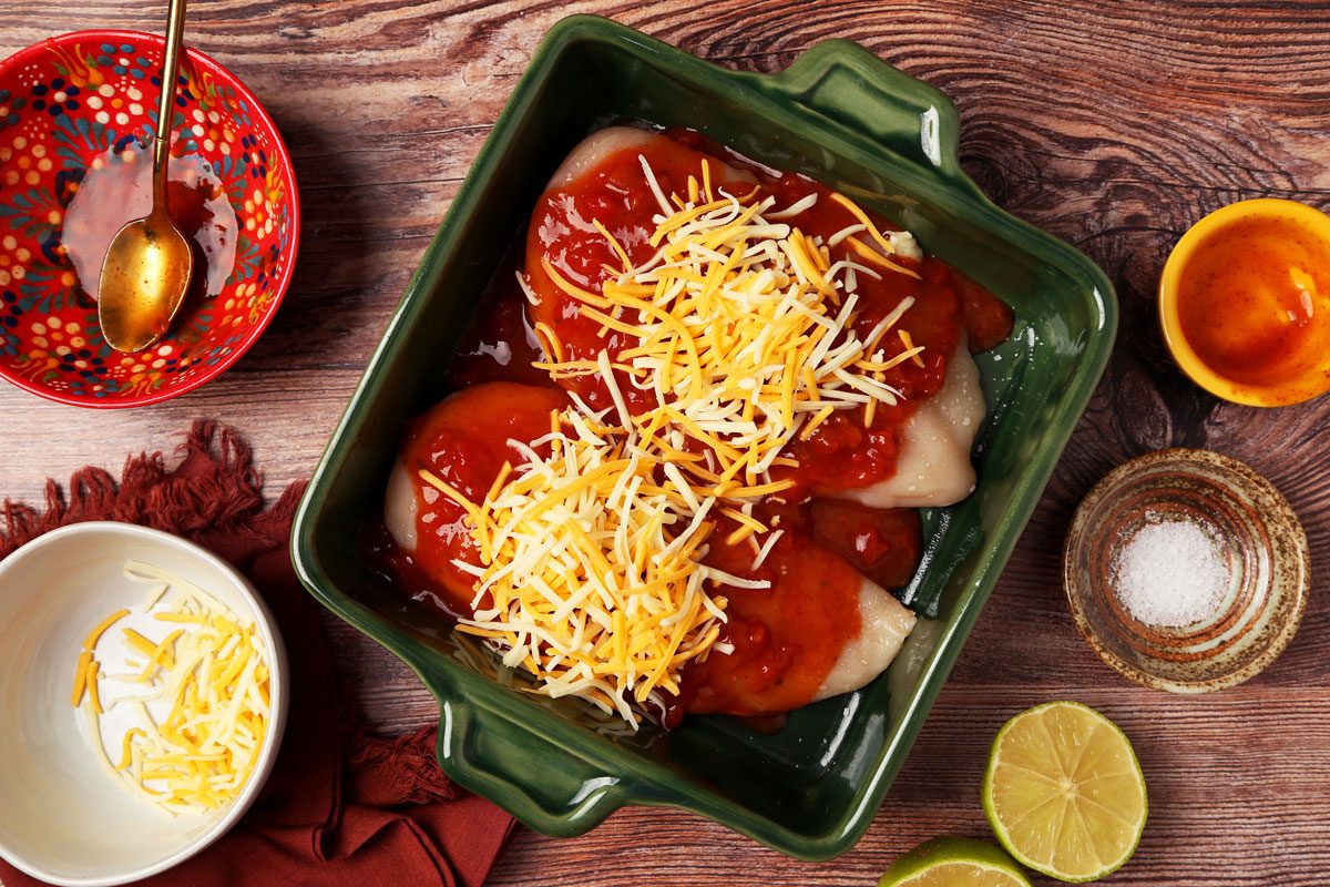 Process of making Taste of Home's Salsa Chicken in a green baking dish on a wooden surface.