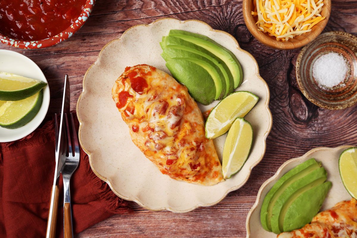 Close up of Taste of Home's Salsa Chicken served on a light brown plate on a wooden surface.
