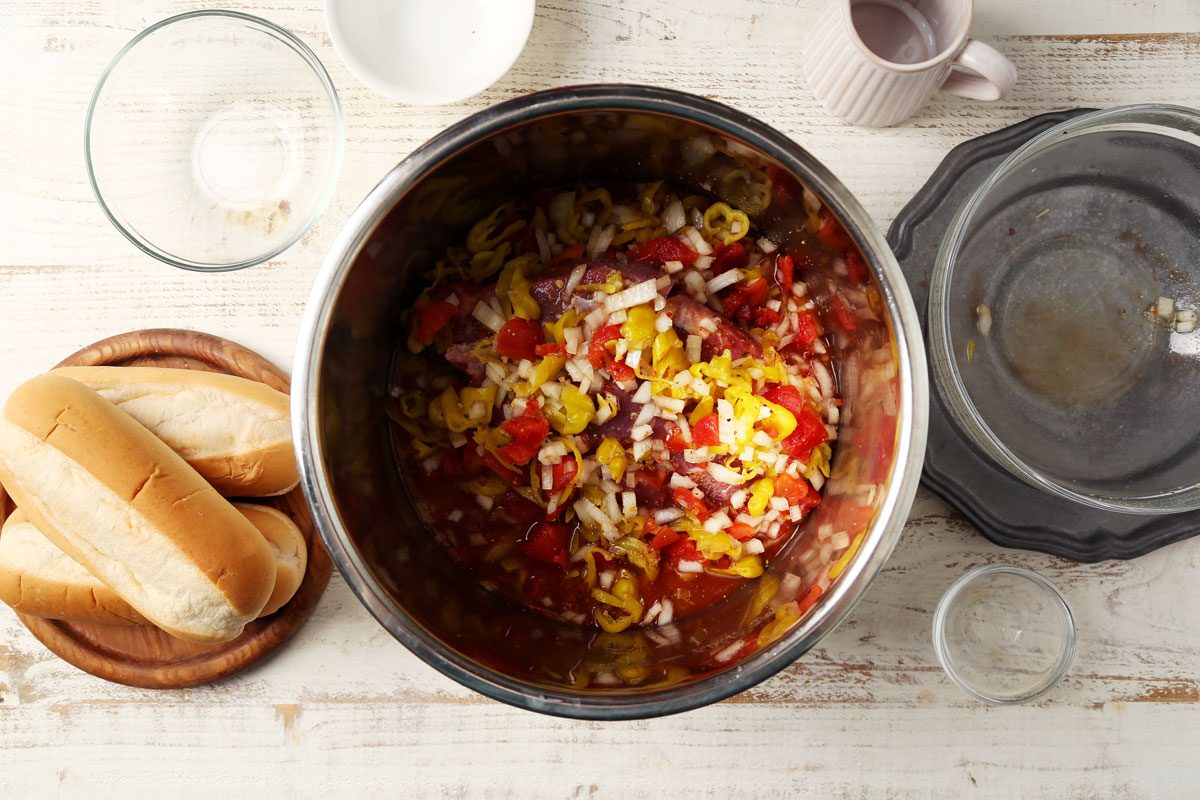 Making Taste of Home's Italian Beef Sandwiches in a slow cooker on a wooden surface.