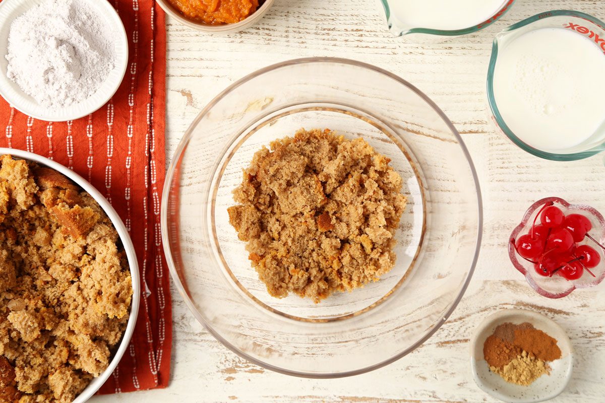 Process of making Taste of Home's Pumpkin Trifle layered in a glass serving bowl on a white wooden surface.
