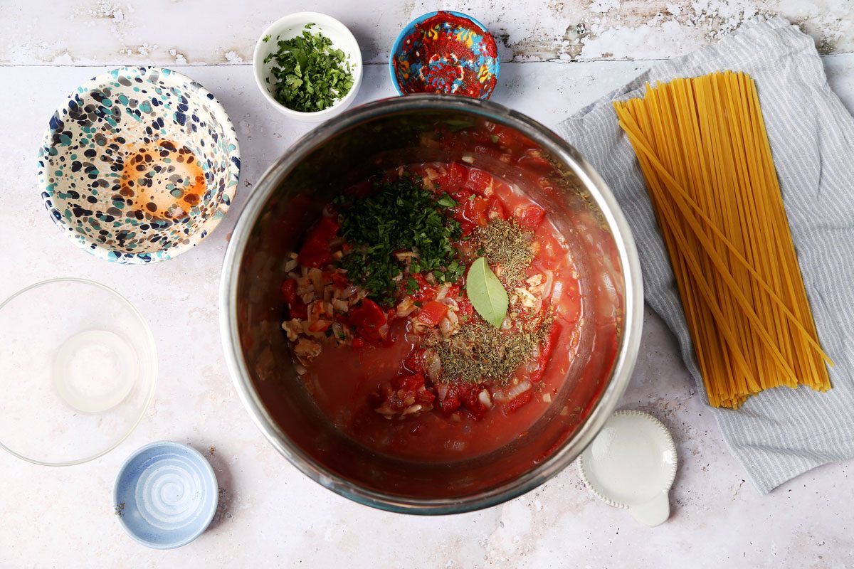 Cooking Taste of Home's Red Clam Sauce in a slow cooker on a grey background.