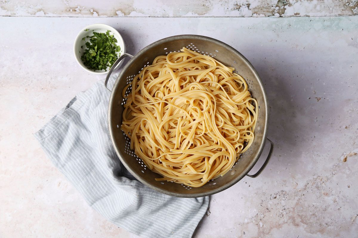 Cooking Taste of Home's Red Clam Sauce in a slow cooker on a grey background.