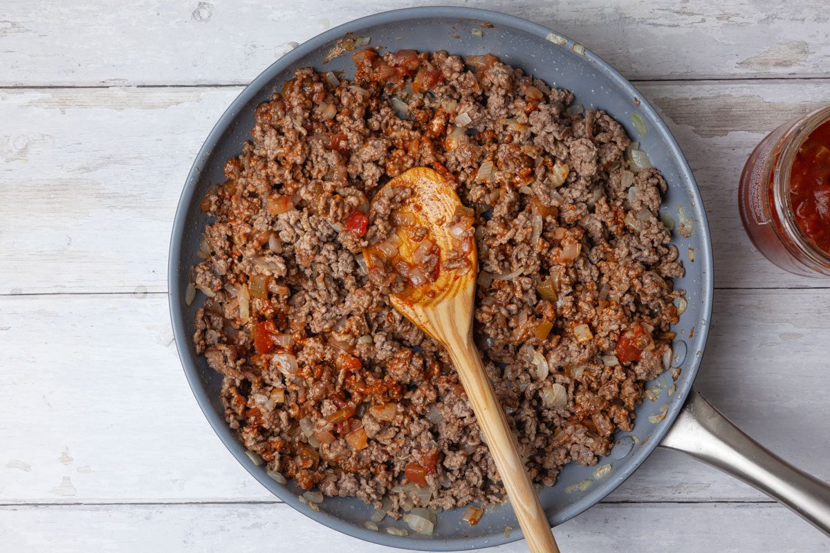Step 2 of Taste of Home Taco Pie is to stir in the salsa, taco seasoning and pepper. Mix well to ensure the seasoning is evenly distributed.