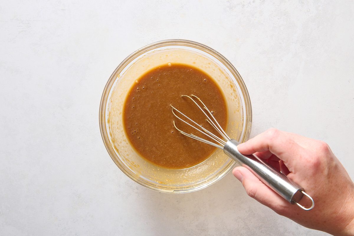 Whisking the peanut sauce in a small bowl