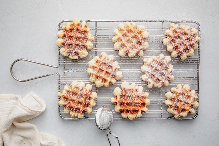 Waffle cookies on a wire rack for Taste of Home Waffle Cookies on a marble surface.