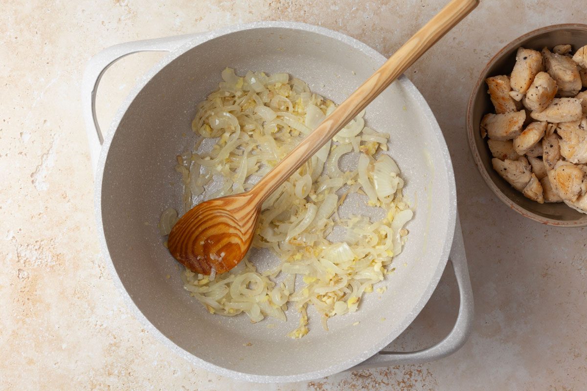 Step 2 of Taste of Home West African Chicken Stew is to saute the onion in the remaining teaspoon of oil until it’s tender. Add the ginger and garlic, then cook for one minute longer.