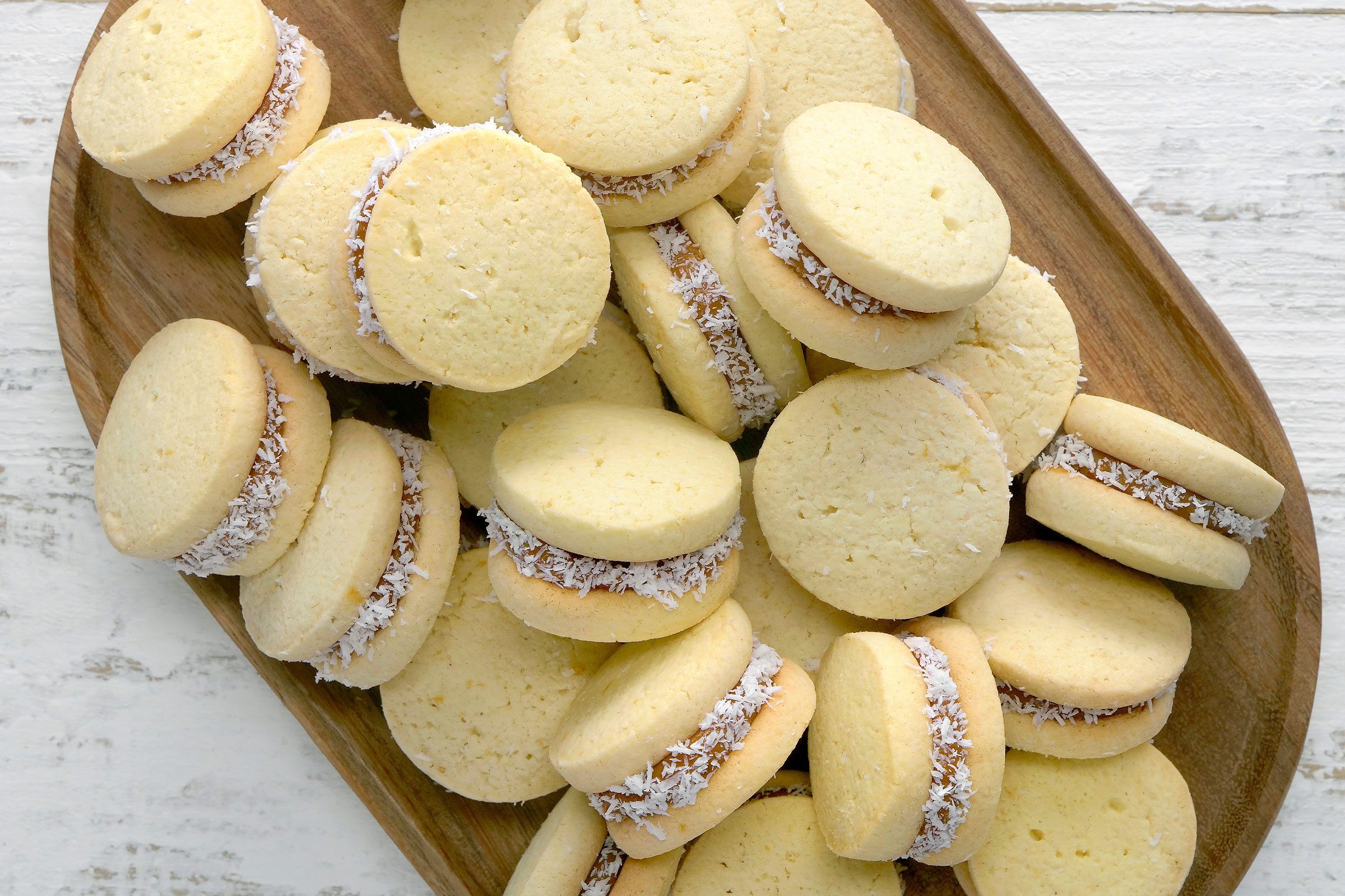 Alfajores cookies on a wooden tray