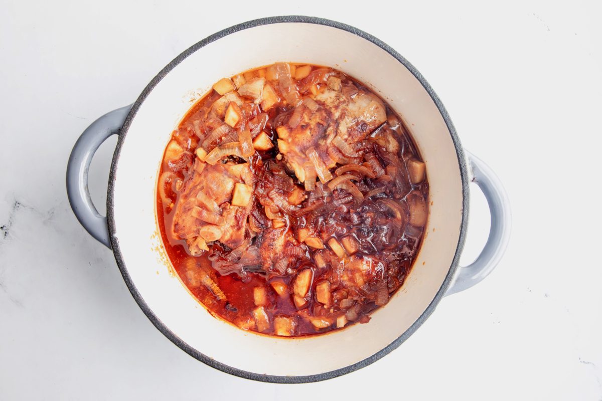 Overhead shot for Taste of Home Apple Chicken with ingredients in a large pot fully cooked.