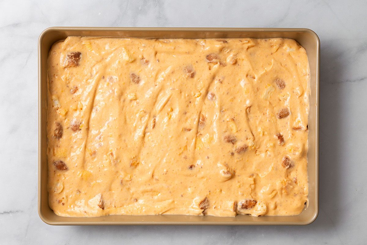 Apricot Delight mixture spread in a pan for step three of Apricot Delight for Taste of Home