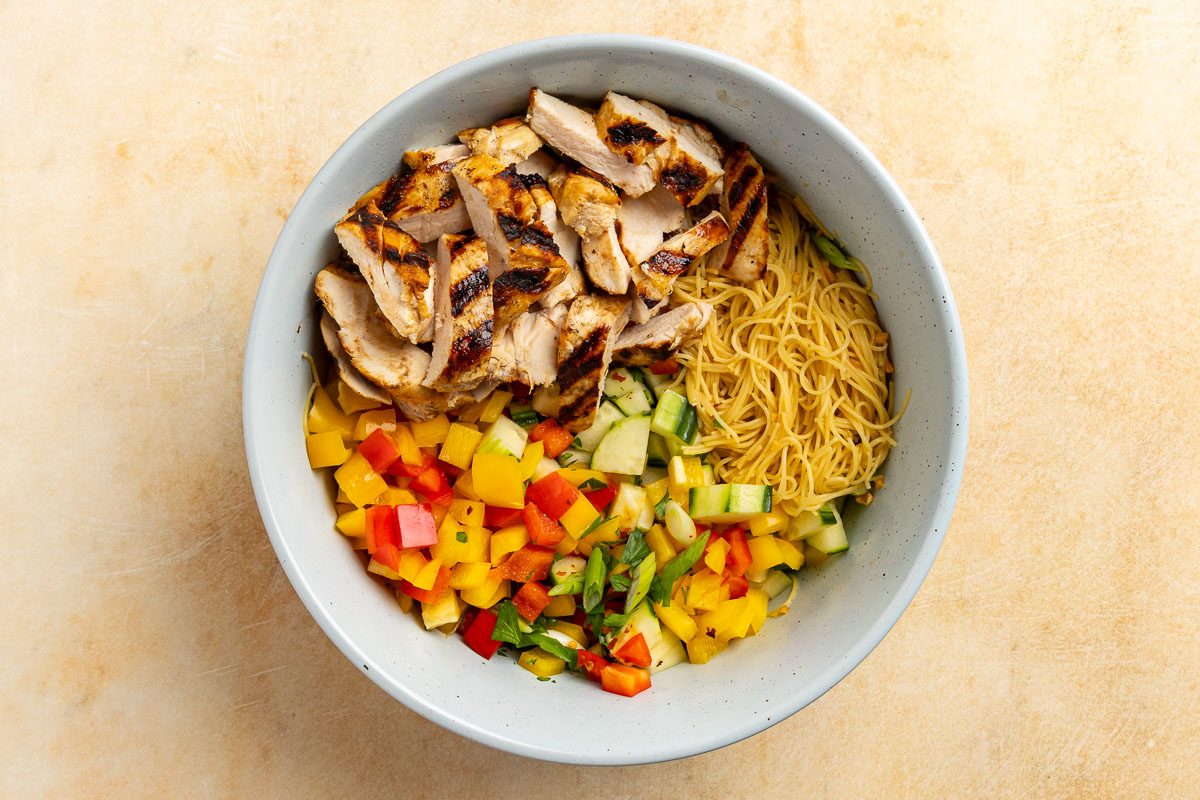 assembling the salad in a large bowl.