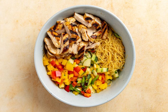 assembling the salad in a large bowl.