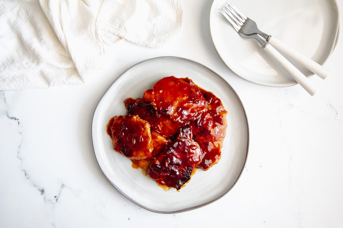 Overhead beauty shot for Taste of Home BBQ Pork Chops being served with two plates.