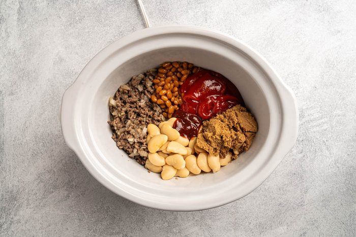 all the ingredients added to the slow cooker.