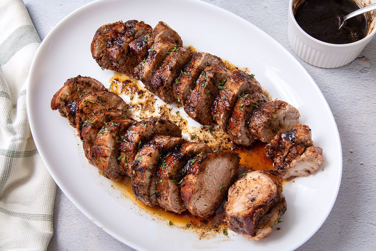 Plated and sliced Balsamic Pork Tenderloin coated with balsamic glaze for Taste of Home