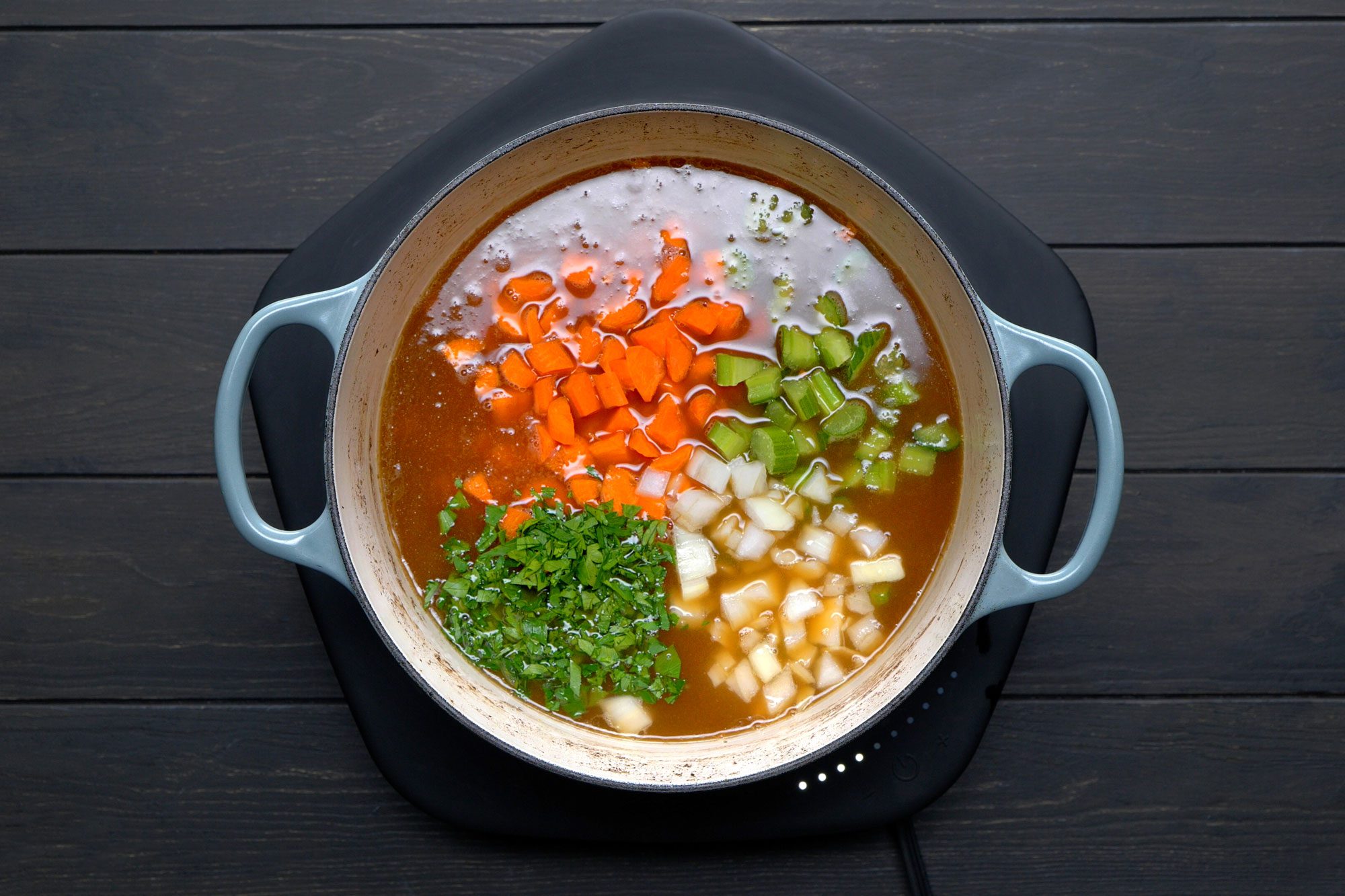 Added carrots, celery, onion and parsley into large saucepan