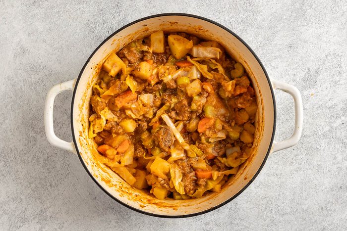 adding tomato sauce to the Beef Cabbage Stew