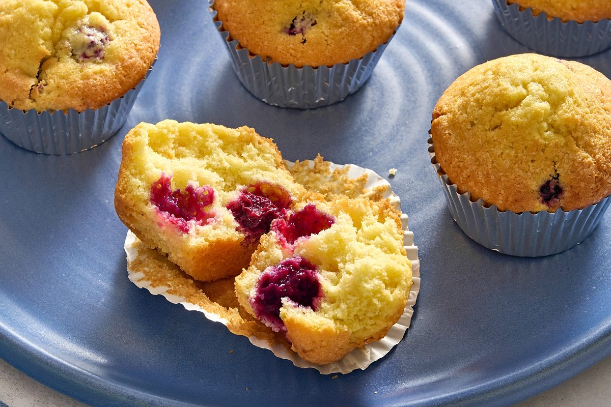 Closeup of a blackberry muffin torn apart to show the interior