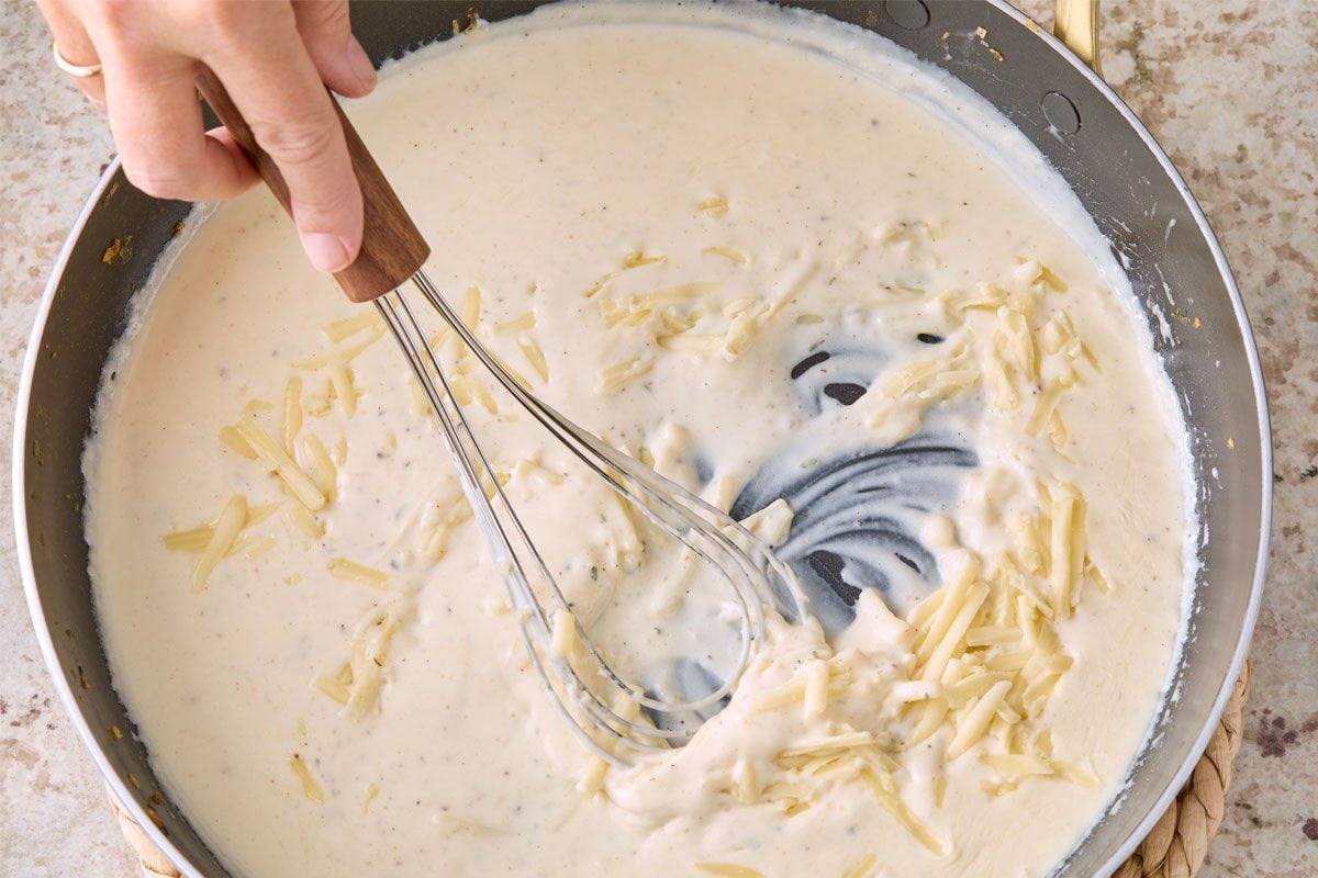 Overhead Shot Of Stir In cheese; Whisk Tool; Marble Surface