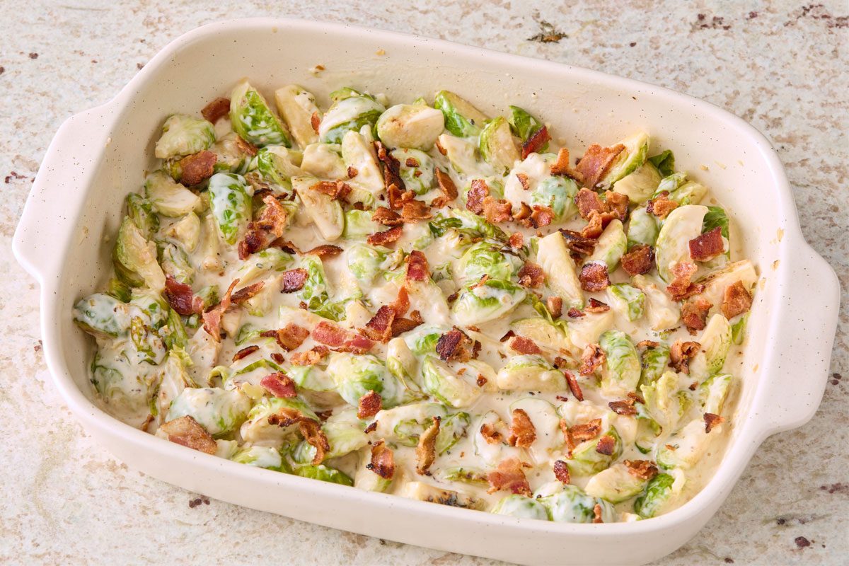 3/4 Angle View Shot Of Sprinkle With Cooked Bacon Crumbles; Marble Surface;