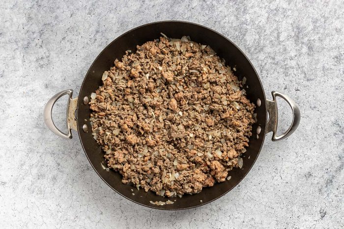 browning the beef and sausage with onion and garlic.