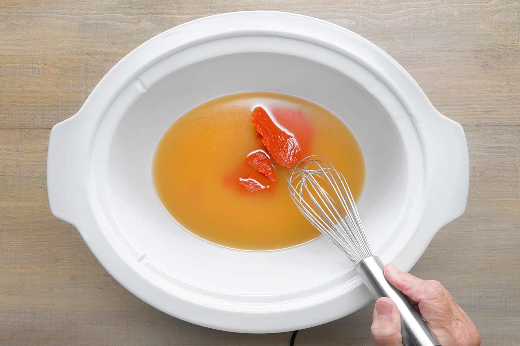 whisk together stock and tomato paste.