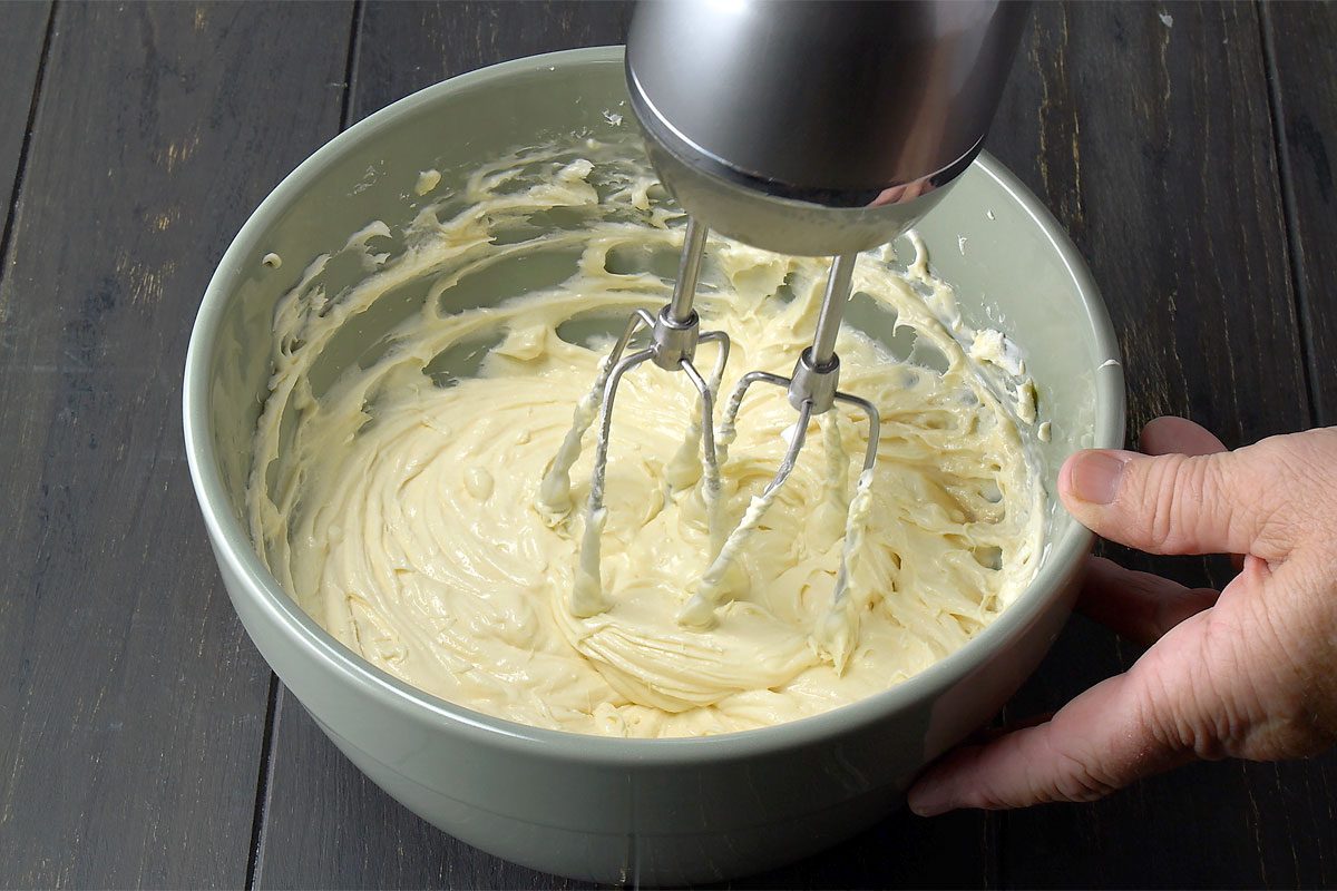 Beat Cream Cheese And Eggs In A Bowl