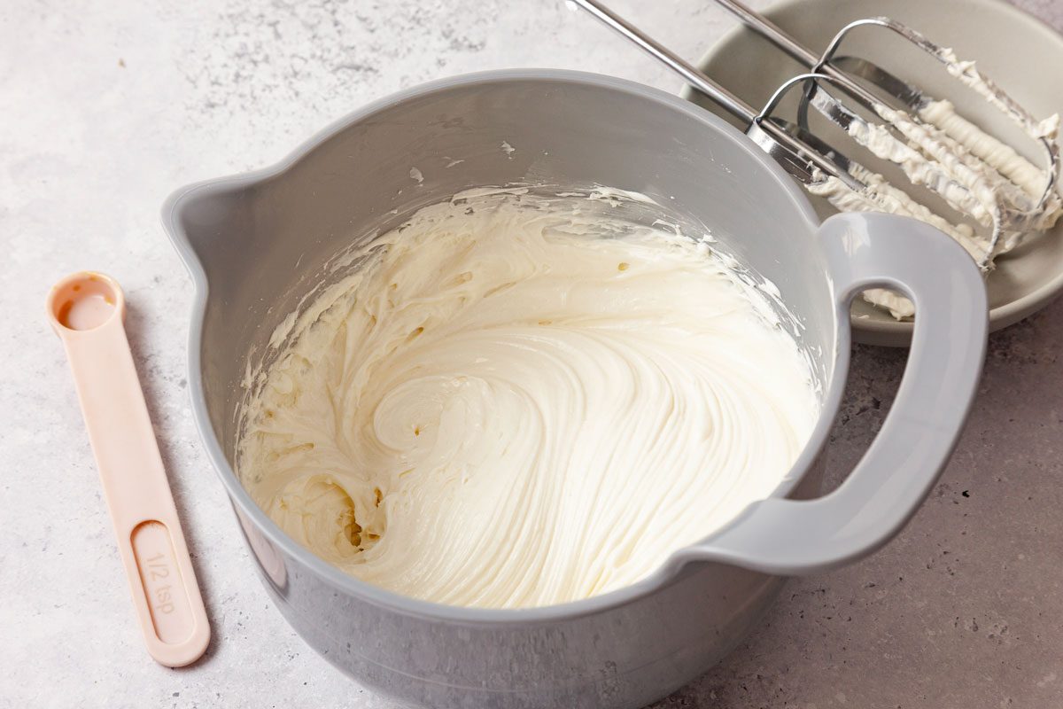 Step 1 of Taste of Home Cheesecake Chimichangas is to beat the softened cream cheese on medium speed until smooth, about four to five minutes. Reduce mixer speed to medium-low and add sugar, sour cream and vanilla extract. Continue to beat until fluffy, about one to two minutes.