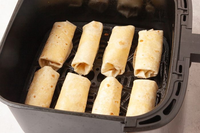 Step 3 of Taste of Home Cheesecake Chimichangas is to Place the chimichangas in a greased air fryer basket, making sure they don’t overlap. Cook for five to seven minutes until golden brown and crispy.