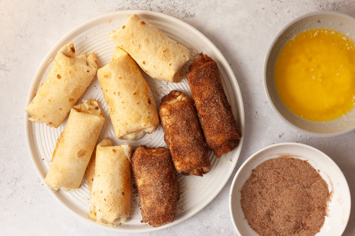 Step 4 of Taste of Home Cheesecake Chimichangas is to mix together brown sugar and cinnamon. Roll the warm chimichangas in melted butter, then toss them in the cinnamon-sugar mixture until evenly coated.