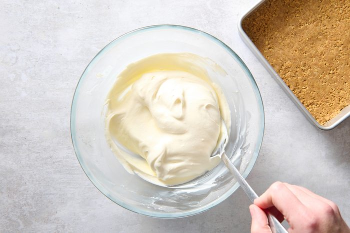 Folding the whipped topping into the cream cheese mixture
