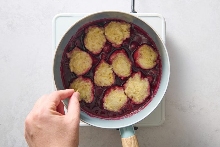 Testing the cooked dumplings with a toothpick