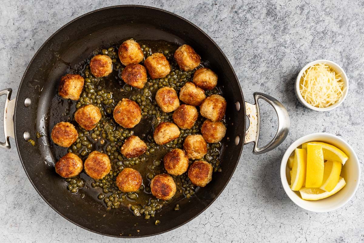 meatballs added back to the skillet with the piccata sauce.