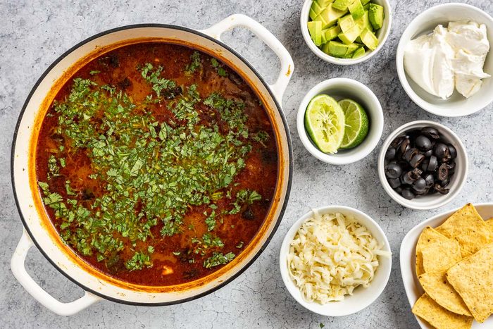Taste of Home Chicken Poblano Soup photo of the cooked soup topped with fresh cilantro and optional toppings.