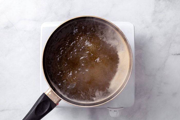Chicken broth and water simmering in a saucepan for Chicken Risotto recipe for Taste of Home