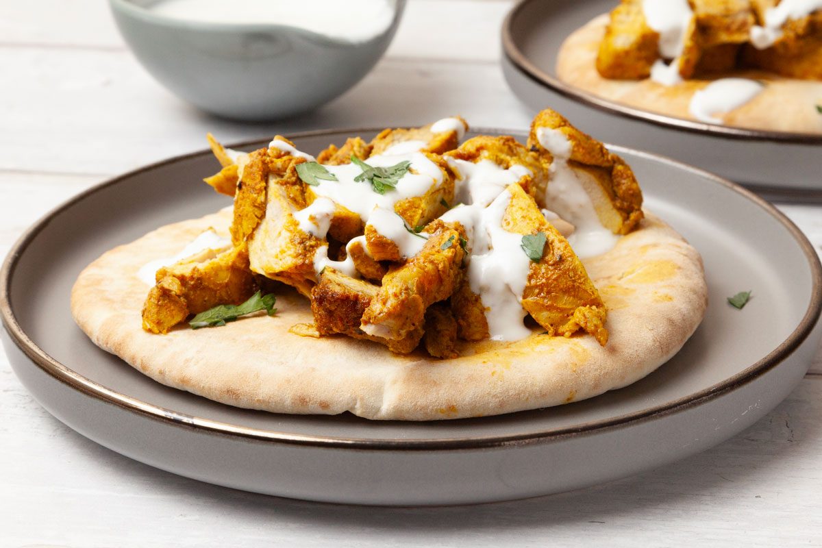 Two single servings of Taste of Home Chicken Shawarma with yogurt sauce
