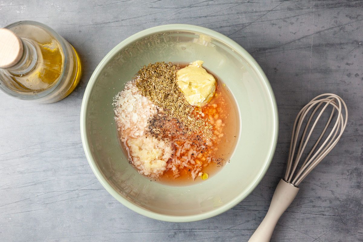 Step 3 of Taste of Home Chickpea Pasta Salad is to whisk together the red wine vinegar, lemon juice, crumbled feta, mustard, garlic, oregano, salt and pepper. Slowly drizzle in the olive oil, while continuing to mix until combined.